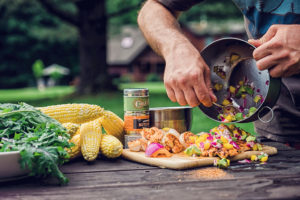 Grilling in front of a log home