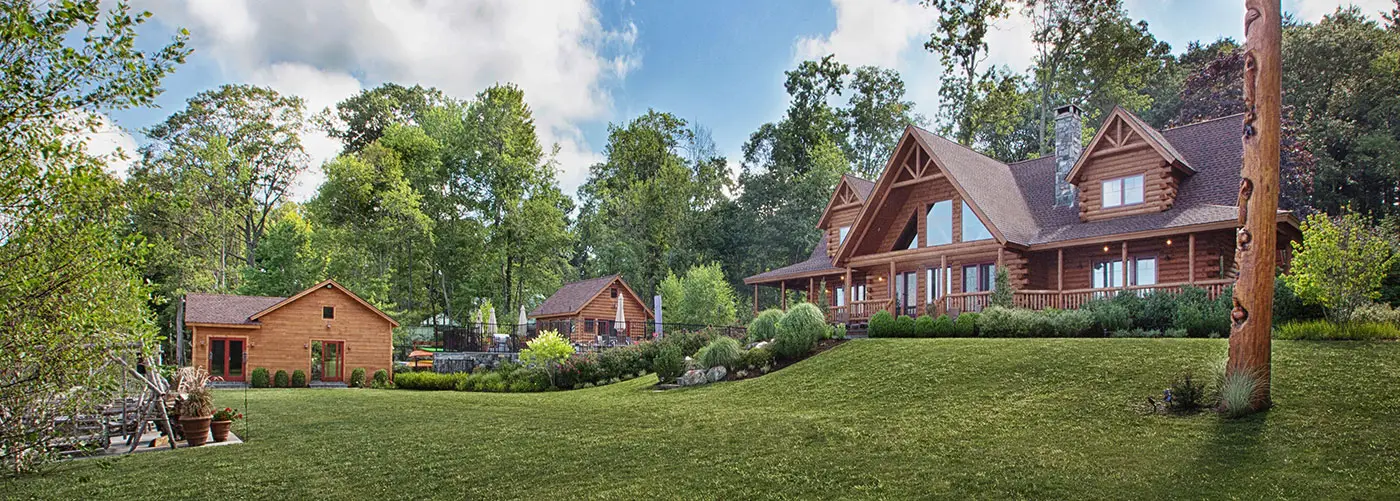 Log Home estate featuring a main home, pool house, apartment and boat house
