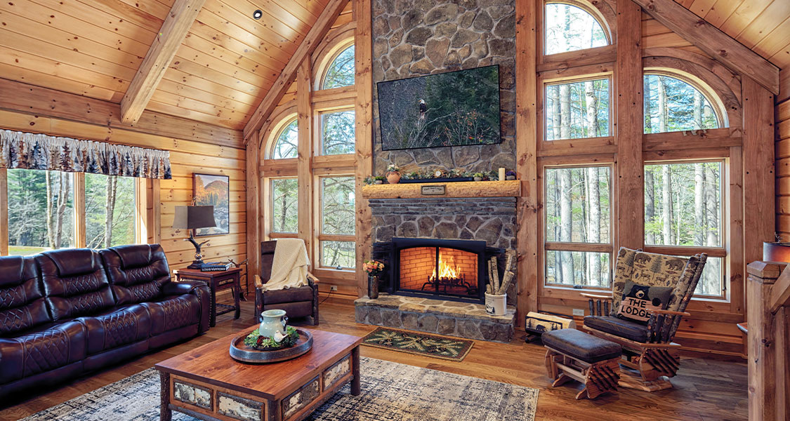 Timber home interior living room with fireplace and view of the Catskill Mountains