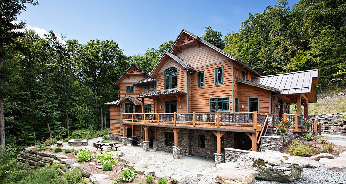 Custom cedar home built on a mountain with custom stonework and landscaping